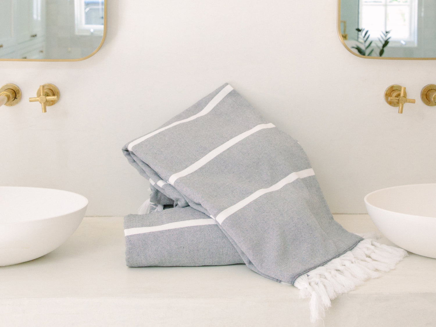 a charcoal grey turkish towel on a bathroom sink