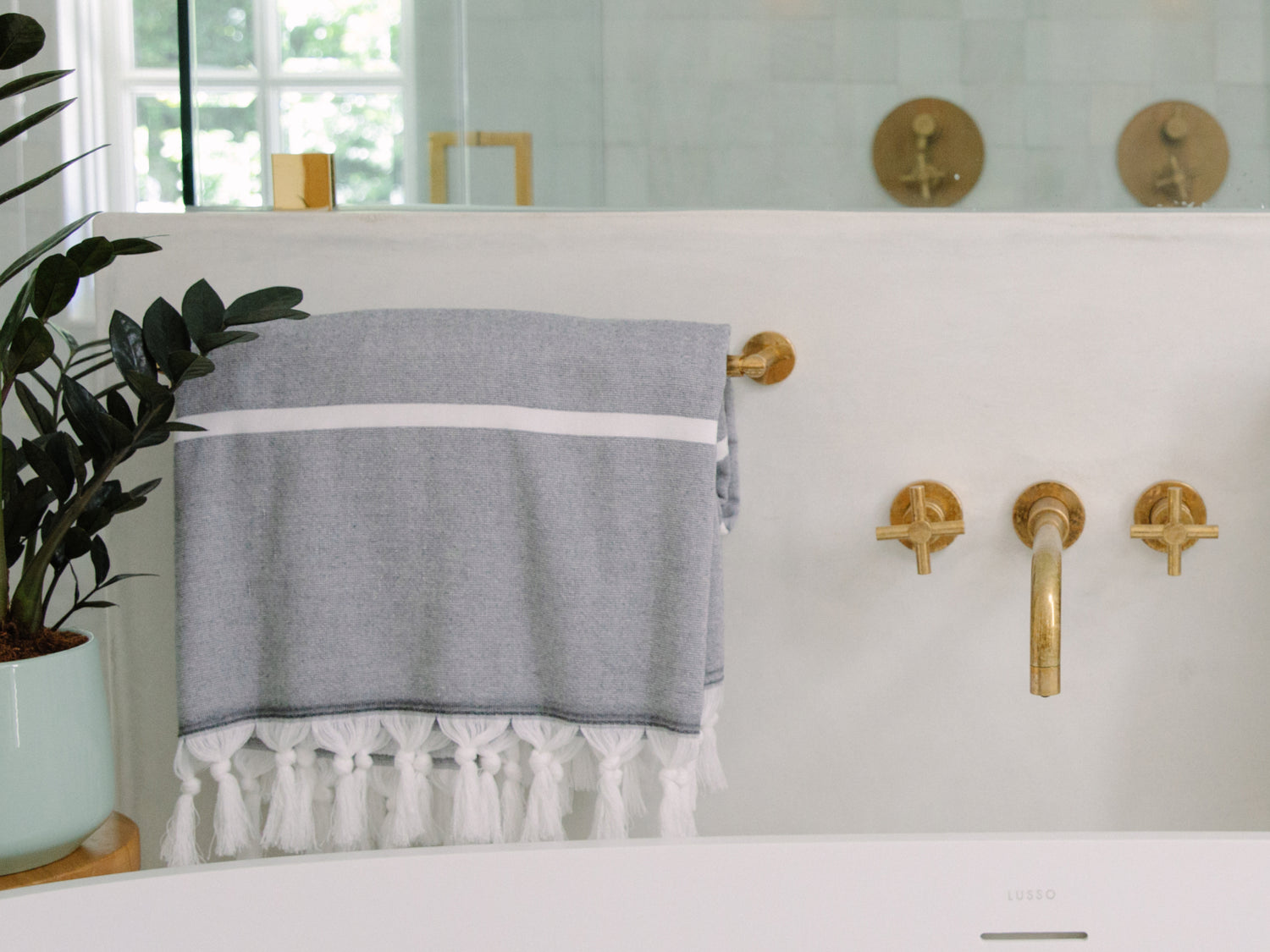 charcoal turkish towel on a towel bar in a minimal bathroom