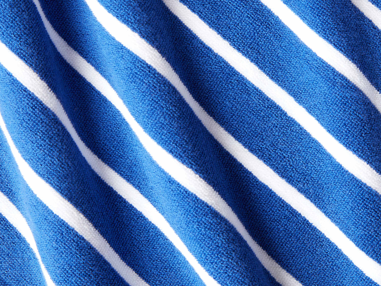 
      A close-up of a thick and soft, blue and white striped cabana beach towel.
    