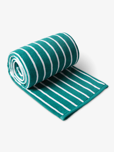 A rolled-up, green and white striped cabana beach towel.
