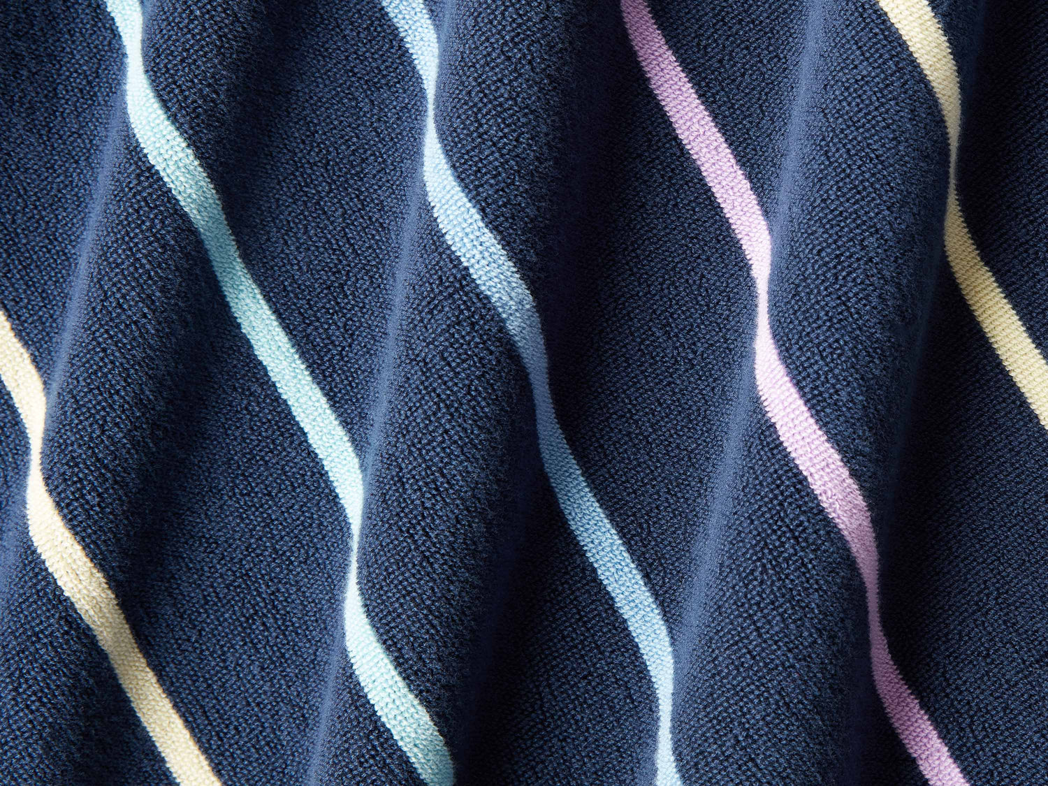 
      A close-up of a thick and soft, navy blue, multicolor-striped cabana beach towel.
    
