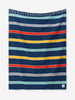 A multicolored blue, orange, and yellow striped Mexican Blanket with tassels laid out.