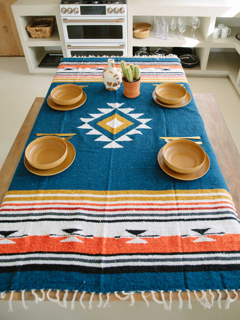 Navy blue Mexican blanket styled as a table cloth in desert kitchen.