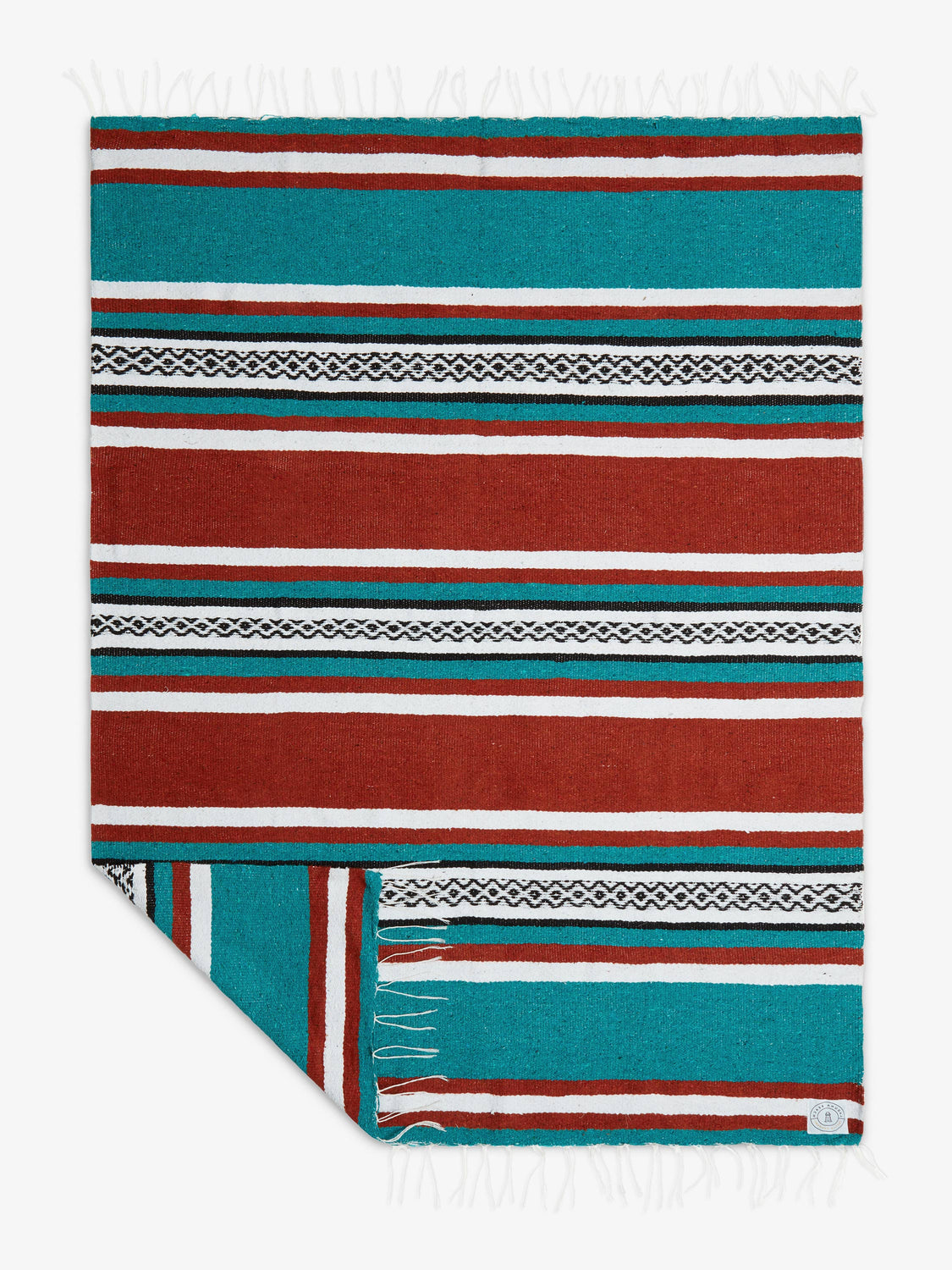 Oversized, traditional Mexican blanket in green, red, and white striped pattern with white fringe spread out.