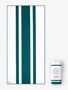 An oversized, quick drying green and white striped microfiber beach towel laid out next to a matching travel bag.