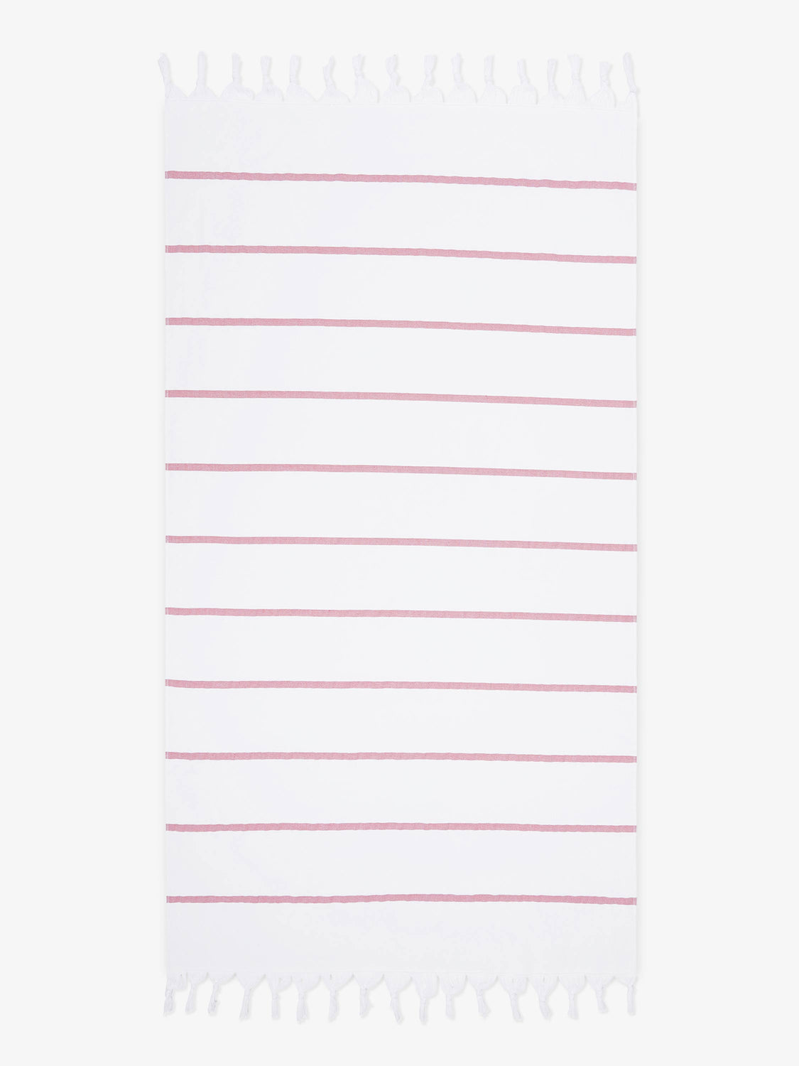 An oversized, white and pink striped Turkish cotton towel with white fringe laid out.