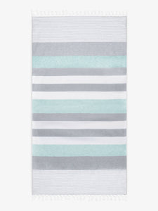 An oversized, teal and gray striped Turkish cotton towel with white fringe laid out.