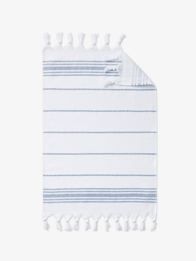 A close-up of a lightweight and absorbent, blue and white striped Turkish cotton and terry cloth hand towel.