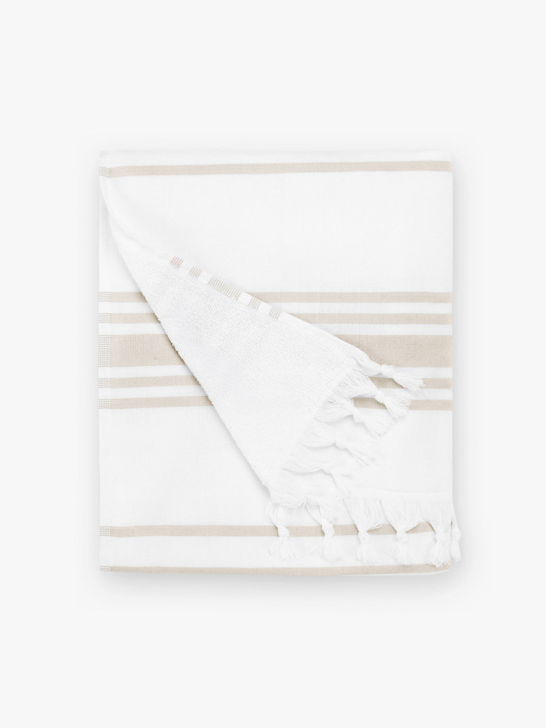 A folded tan and white striped Turkish hand towel with white fringe.