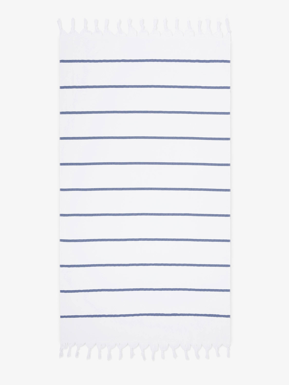 An oversized, navy and white striped Turkish cotton towel with white fringe laid out.
