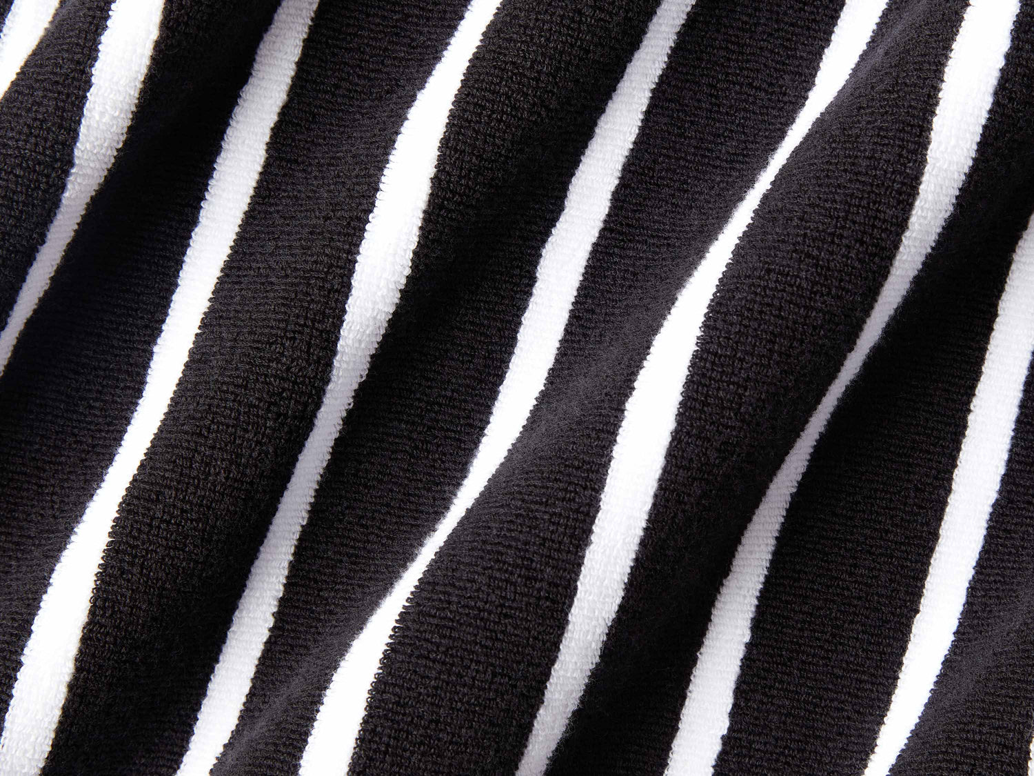 
      A close-up of a thick and soft, black and white striped cabana beach towel.
    