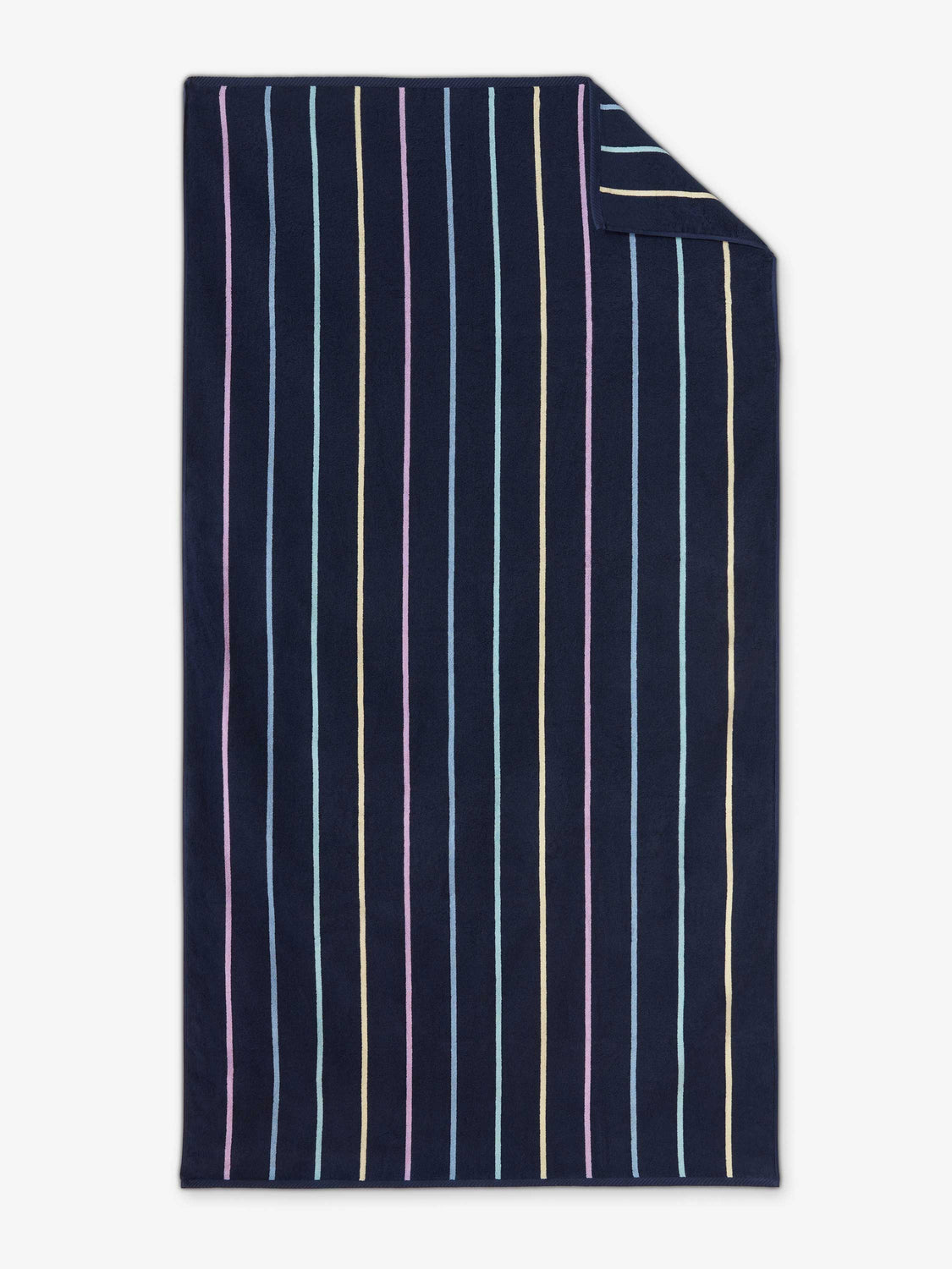 An oversized, navy blue and multicolor-striped cabana beach towel laid out.