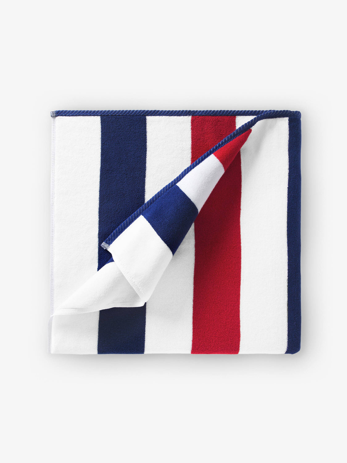 A folded red, white, and blue striped cabana beach towel.