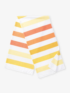 A folded yellow, orange, and white striped cabana beach towel.