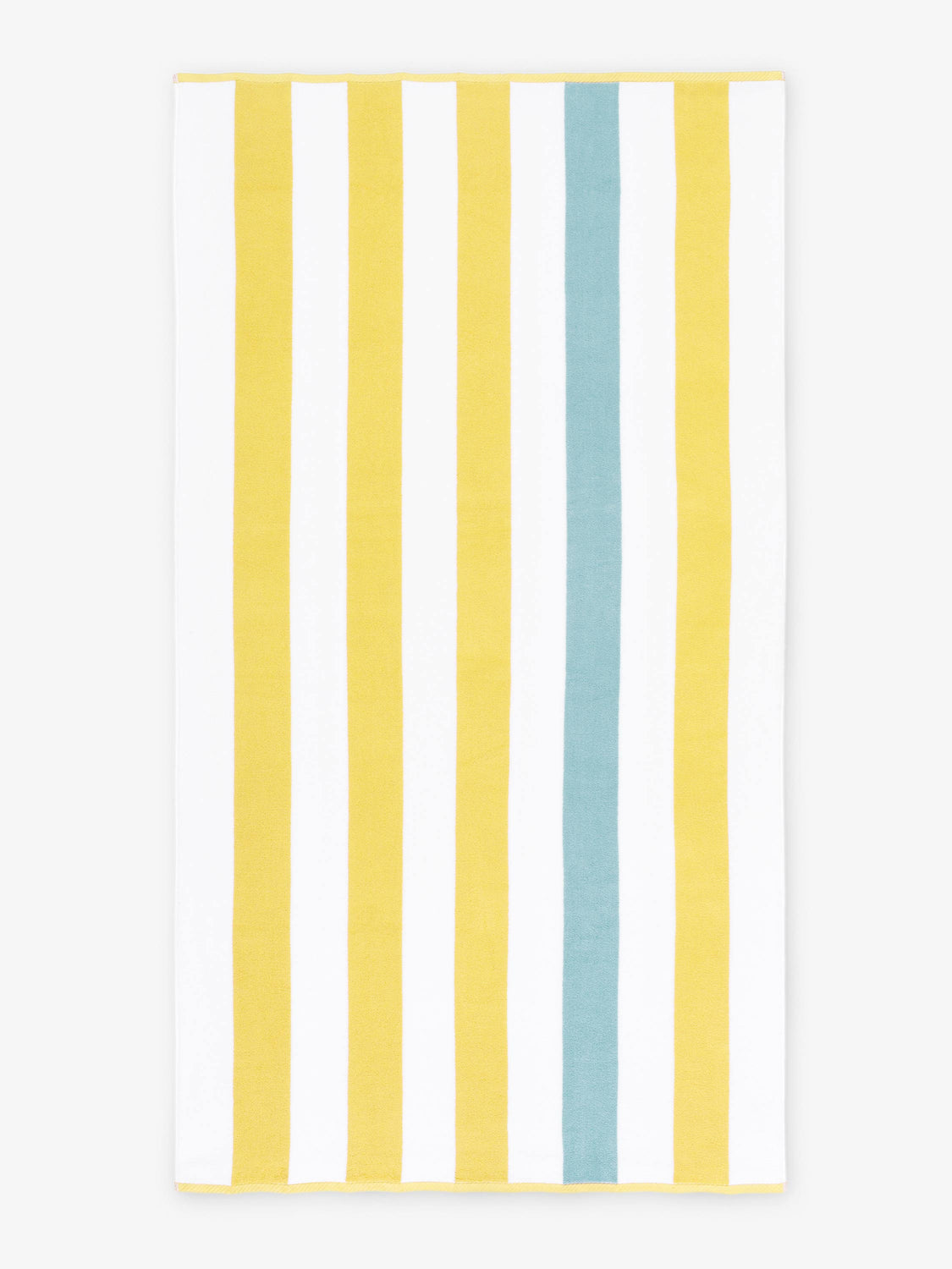 An oversized, yellow, green, and white striped cabana beach towel laid out.