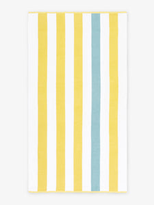 An oversized, yellow, green, and white striped cabana beach towel laid out.