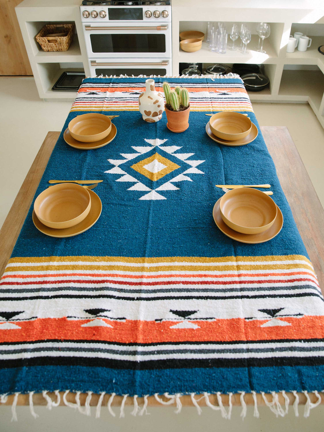 Navy blue Mexican blanket styled as a table cloth in desert kitchen.