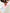 A man doing a yoga pose on a pink yoga mat with a gray, green, and white Mexican blanket folded in front of him.  Blanket Selena Gomez was wrapped on on her Instagram Story. Selena Gomez Mexican Blanket.