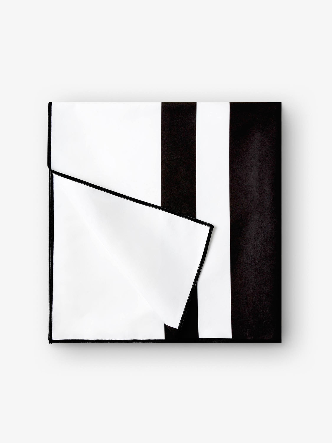A folded quick drying, black and white striped microfiber beach towel.