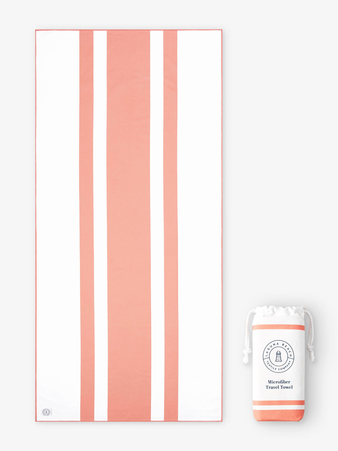 An oversized, quick drying coral and white striped microfiber beach towel laid out next to a matching travel bag. 