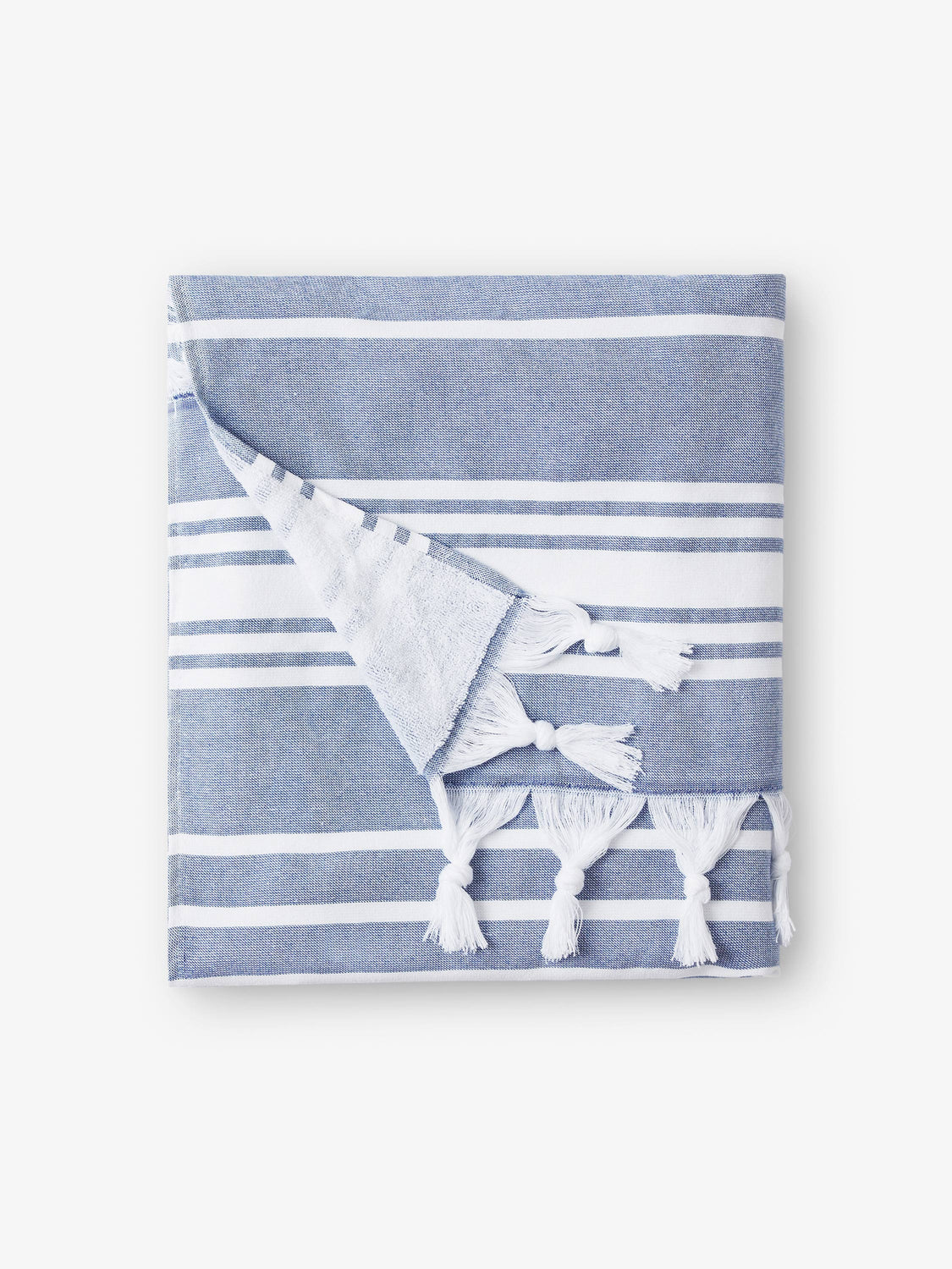 A folded blue and white striped Turkish towel with white fringe.