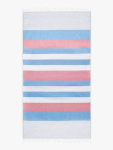 An oversized, blue, pink, and white striped Turkish cotton towel with white fringe laid out.