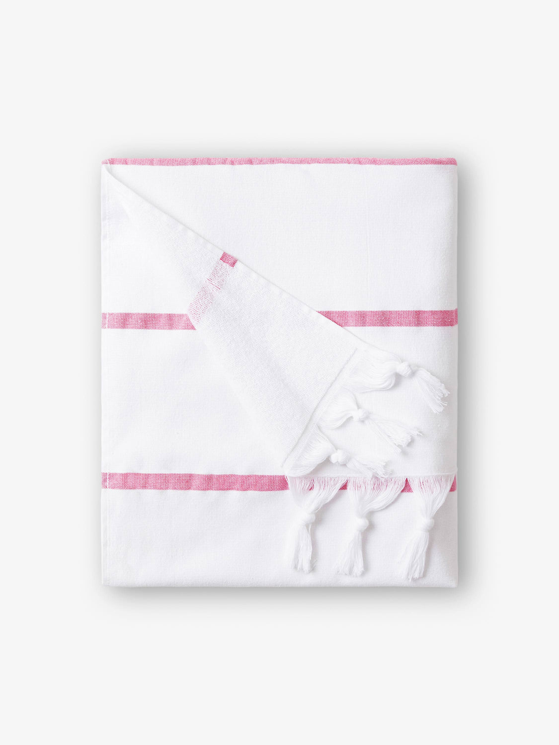 A folded white and pink striped Turkish towel with white fringe.