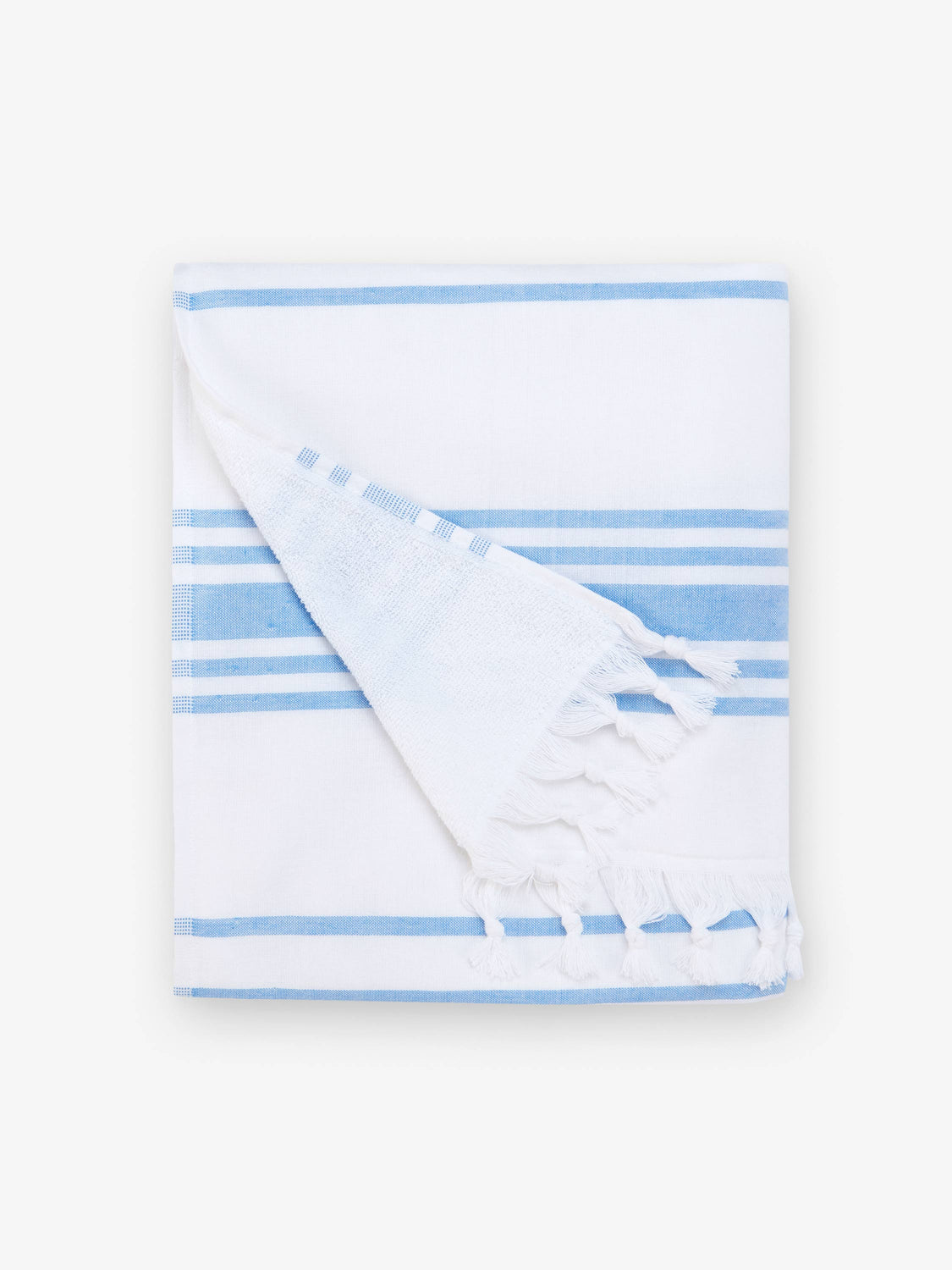 A folded white and light blue striped Turkish towel with white fringe.