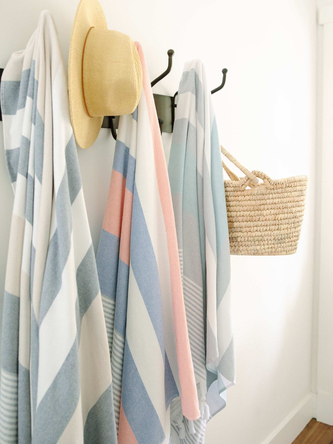 Three extra large striped Turkish towels hanging side by side.