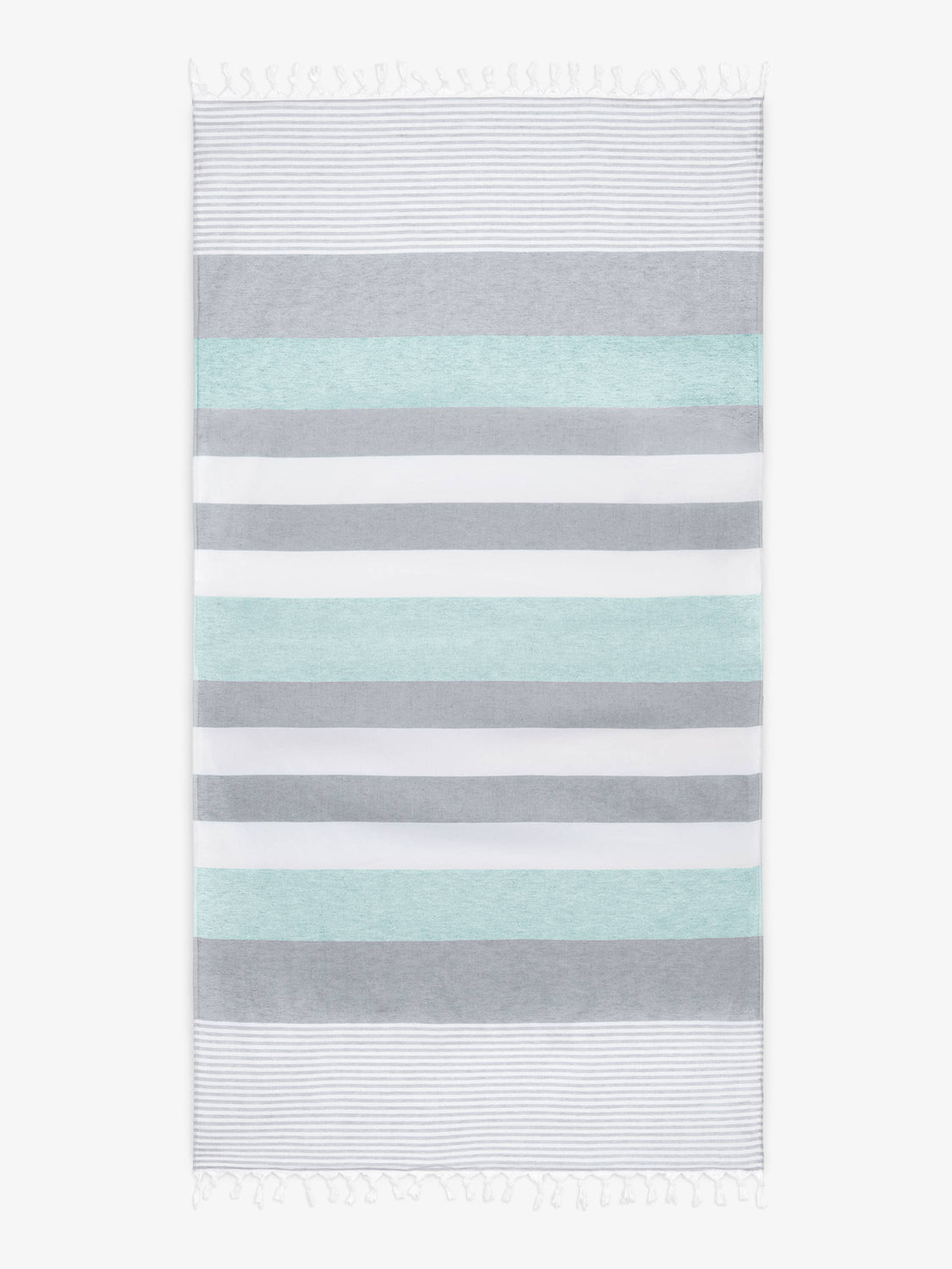 An oversized, teal and gray striped Turkish cotton towel with white fringe laid out. 