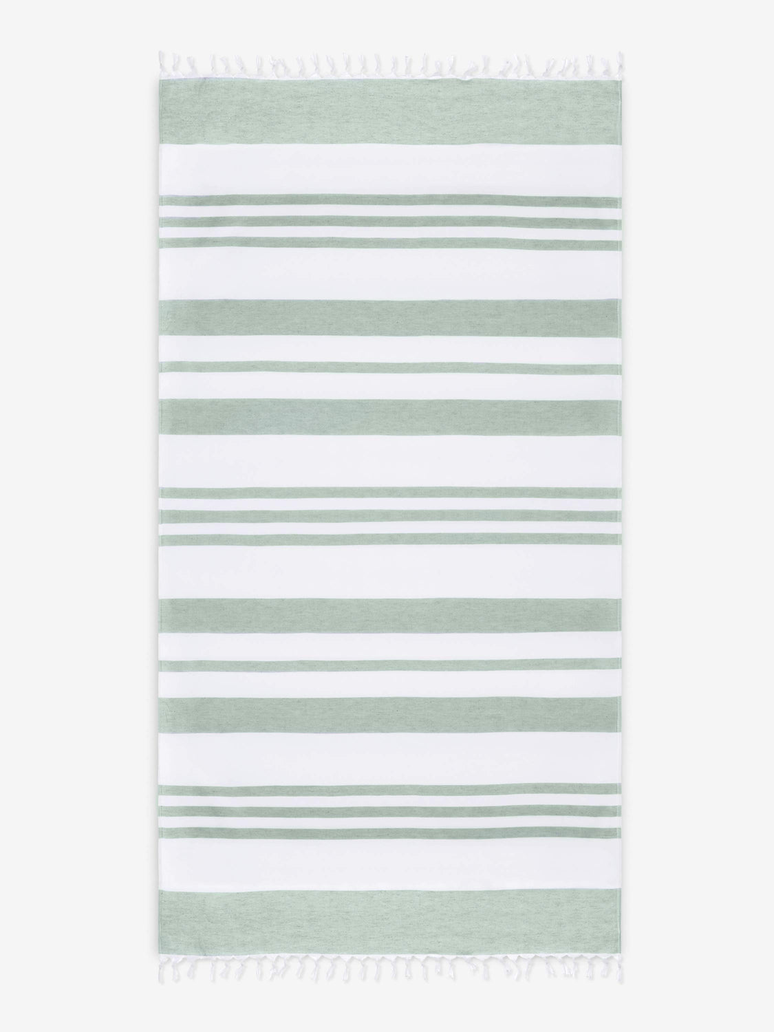An oversized, green and white striped Turkish cotton towel with white fringe laid out. 